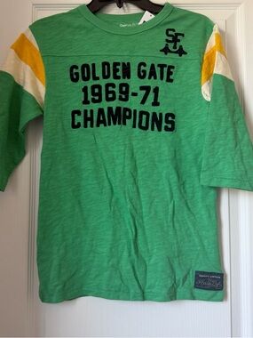 New Boy Gap Green "Golden Gate 1969-71 Champions" Tee